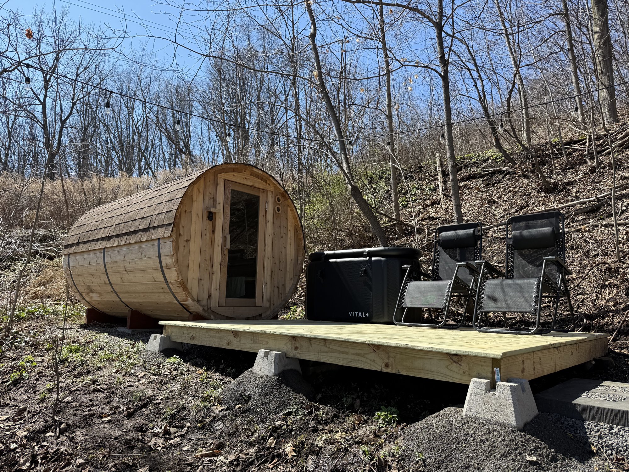 Cedar barrel sauna exterior with cold plunge